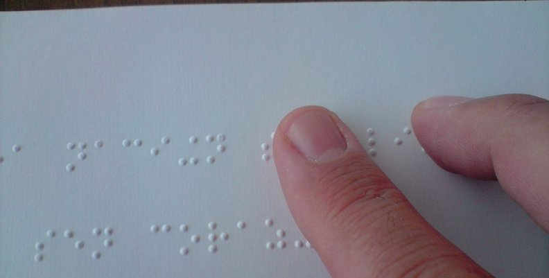 1024px-A_person_reading_a_braille_book 1024px-A_person_reading_a_braille_book