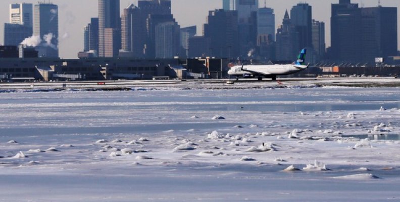 A Jet Blue flight waits to take off from Logan Airport next to the frozen waters of the harbour between Winthrop and Boston A Jet Blue flight waits to take off from Logan Airport next to the frozen waters of the harbour between Winthrop and Boston