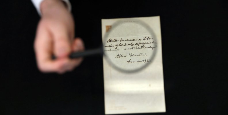 A note written on a Tokyo hotel official paper in 1922 by Albert Einstein is seen before it is sold at an auction in Jerusalem A note written on a Tokyo hotel official paper in 1922 by Albert Einstein is seen before it is sold at an auction in Jerusalem