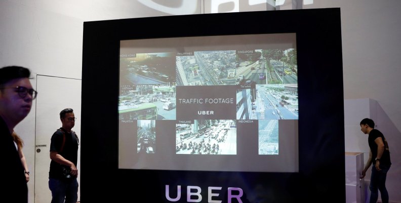 A screen shows the traffic conditions in cities across Asia during an Uber event in Singapore A screen shows the traffic conditions in cities across Asia during an Uber event in Singapore