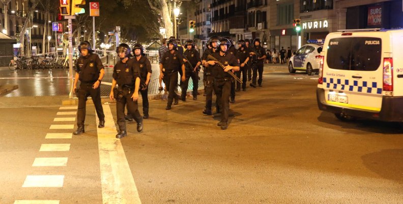 Armed Catalonian Mosses de Escuadra officers leave the area where a van crashed into pedestrians at Las Ramblas in Barcelona Armed Catalonian Mosses de Escuadra officers leave the area where a van crashed into pedestrians at Las Ramblas in Barcelona
