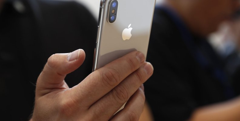 Attendee checks out new iPhone X during an Apple launch event in Cupertino Attendee checks out new iPhone X during an Apple launch event in Cupertino