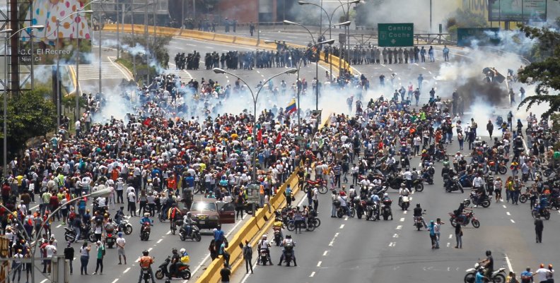 Demonstrators clash with riot police while ralling against Venezuela's President Nicolas Maduro's government in Caracas Demonstrators clash with riot police while ralling against Venezuela's President Nicolas Maduro's government in Caracas