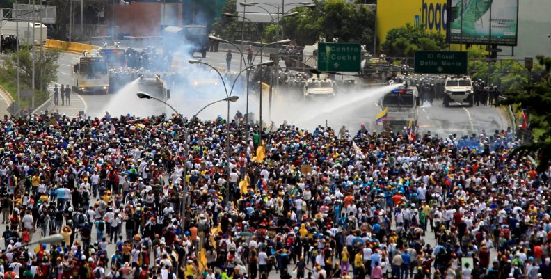Demonstrators clash with riot security forces while rallying against Venezuela's President Nicolas Maduro in Caracas Demonstrators clash with riot security forces while rallying against Venezuela's President Nicolas Maduro in Caracas