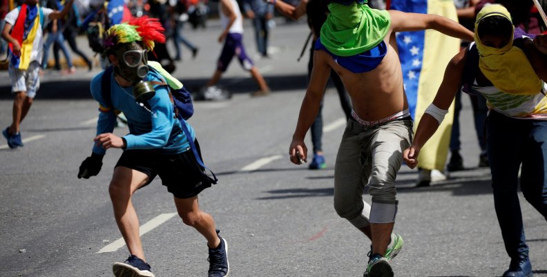 Demonstrators clash with riot security forces while rallying against Venezuela's President Nicolas Maduro's government in Caracas