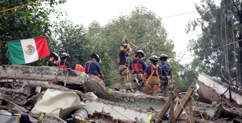 Mexican fire fighters work through the rubble of a collapsed multi family residential, after an earthquake, in Mexico City