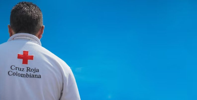 Cruz Roja Hombre de espaldas con camisa blanca y logo de una cruz roja