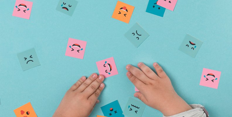 El arte escénico en la televisión pública: una herramienta para manejar las emociones Niño jugando con cuadros con caras dibujadas - Imagen por Freepik