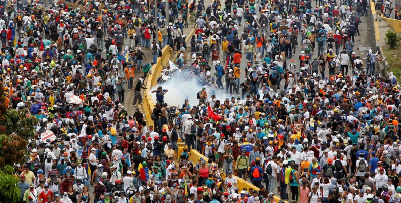Opposition supporters clash with riot police during a rally against President Nicolas Maduro in Caracas Opposition supporters clash with riot police during a rally against President Nicolas Maduro in Caracas