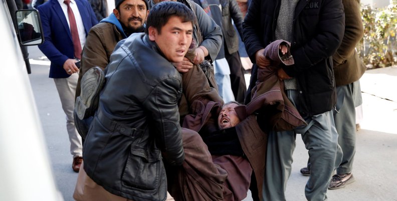 People carry a mourning man at a hospital after a suicide attack in Kabul People carry a mourning man at a hospital after a suicide attack in Kabul