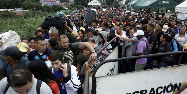 People queue to try to cross into Venezuela from Colombia through the Simon Bolivar international bridge in Cucuta People queue to try to cross into Venezuela from Colombia through the Simon Bolivar international bridge in Cucuta