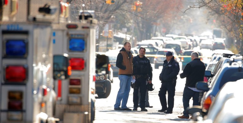 Police gather outside a house in the Brooklyn borough, while they investigate an earlier incident of the reported explosion at the New York Port Authority Bus Terminal in Manhattan, in New York City Police gather outside a house in the Brooklyn borough, while they investigate an earlier incident of the reported explosion at the New York Port Authority Bus Terminal in Manhattan, in New York City