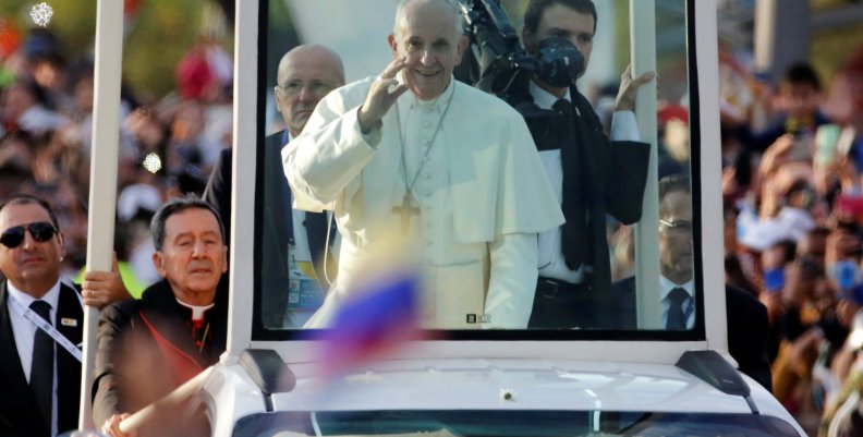 Pope Francis waves at the faithfuls as he travels in the popemobile through Bogota Pope Francis waves at the faithfuls as he travels in the popemobile through Bogota