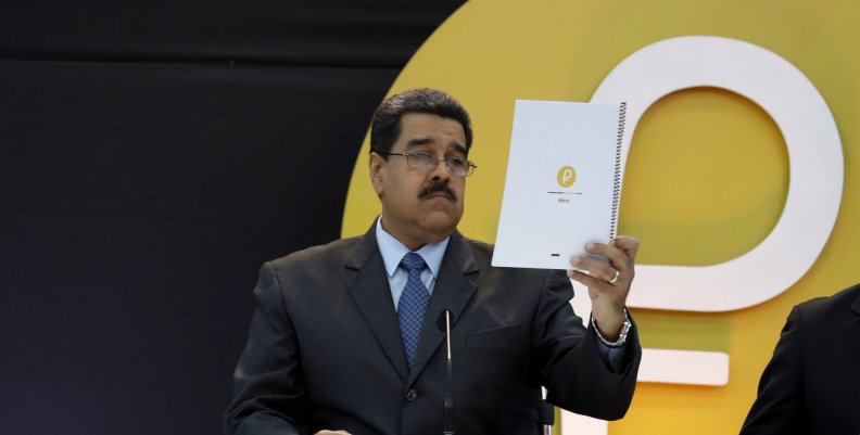 Venezuela's President Nicolas Maduro reads a document during the event launching the new Venezuelan cryptocurrency "Petro" in Caracas Venezuela's President Nicolas Maduro reads a document during the event launching the new Venezuelan cryptocurrency "Petro" in Caracas
