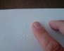 1024px-A_person_reading_a_braille_book