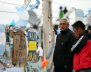 A man reacts in front of signs and messages in support of the 44 crew members of the missing at sea ARA San Juan submarine on a fence at an Argentine naval base in Mar del Plata