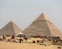 FILE PHOTO: A group of camels and horses stand idle in front of the Great Pyramids awaiting tourists in Giza