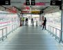 Estación de transMilenio por dentro un pacillo con piso metálico y puertas de cristal a los lados