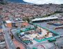 Obra en construcción: hay grúas amarillas y materiales dispersados