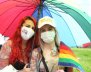 Dos mujeres bajo una sombrilla de colores