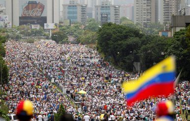 Demonstrators clash with riot police during the so-called "mother of all marches" against Venezuela's President Maduro in Caracas