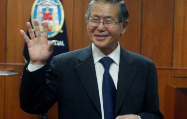 FILE PHOTO -  Peru's former President Alberto Fujimori waves as he enters the courtroom before his trial at the Special Police Headquarters in Lima