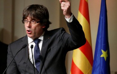 Former Catalan leader Carles Puigdemont gestures during a meeting with Catalan mayors in Brussels