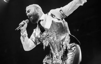 Cantante en una tarima vestido con traje 