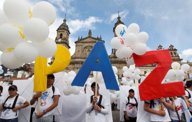 People form the word Peace with letters at the Bolivar square outside the cathedral in Bogota