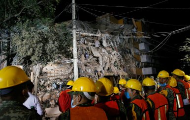 Rescuers work at the site of a collapsed building after an earthquake in Mexico City