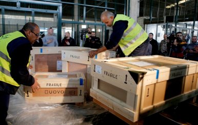 Workers unload boxes of artefacts at Beirut's International Airport